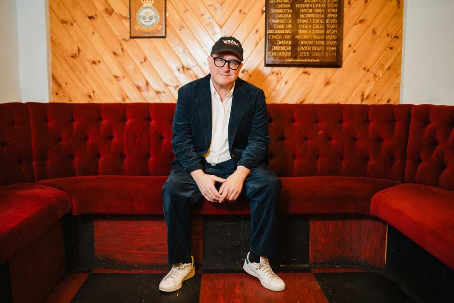 Craig 芬恩 photographed seated on a couch.